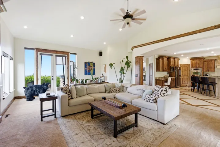 Living room featuring recessed lighting, ceiling fan, light carpet, french doors, and vaulted ceiling