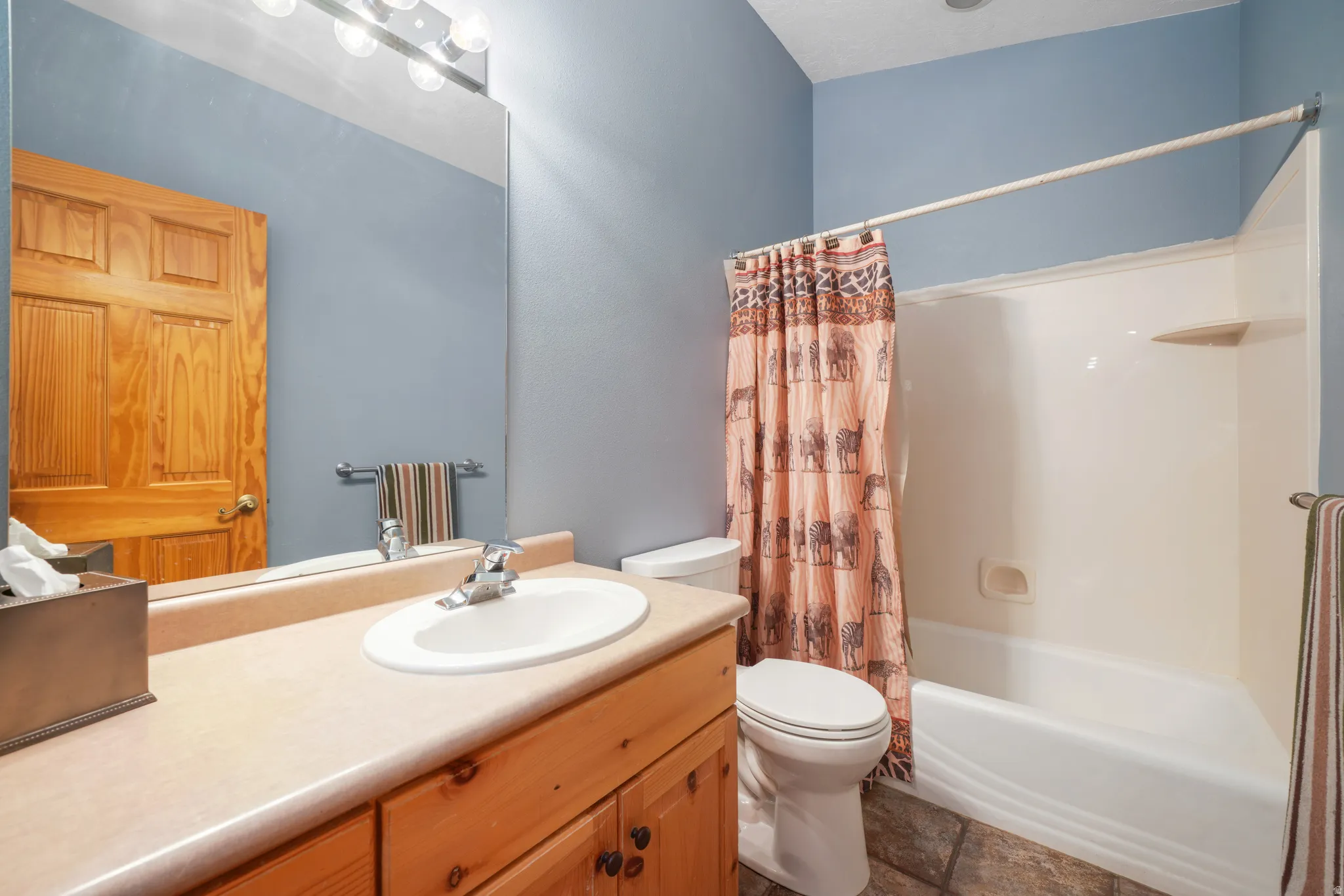 Full bathroom featuring vanity and shower / bath combo with shower curtain