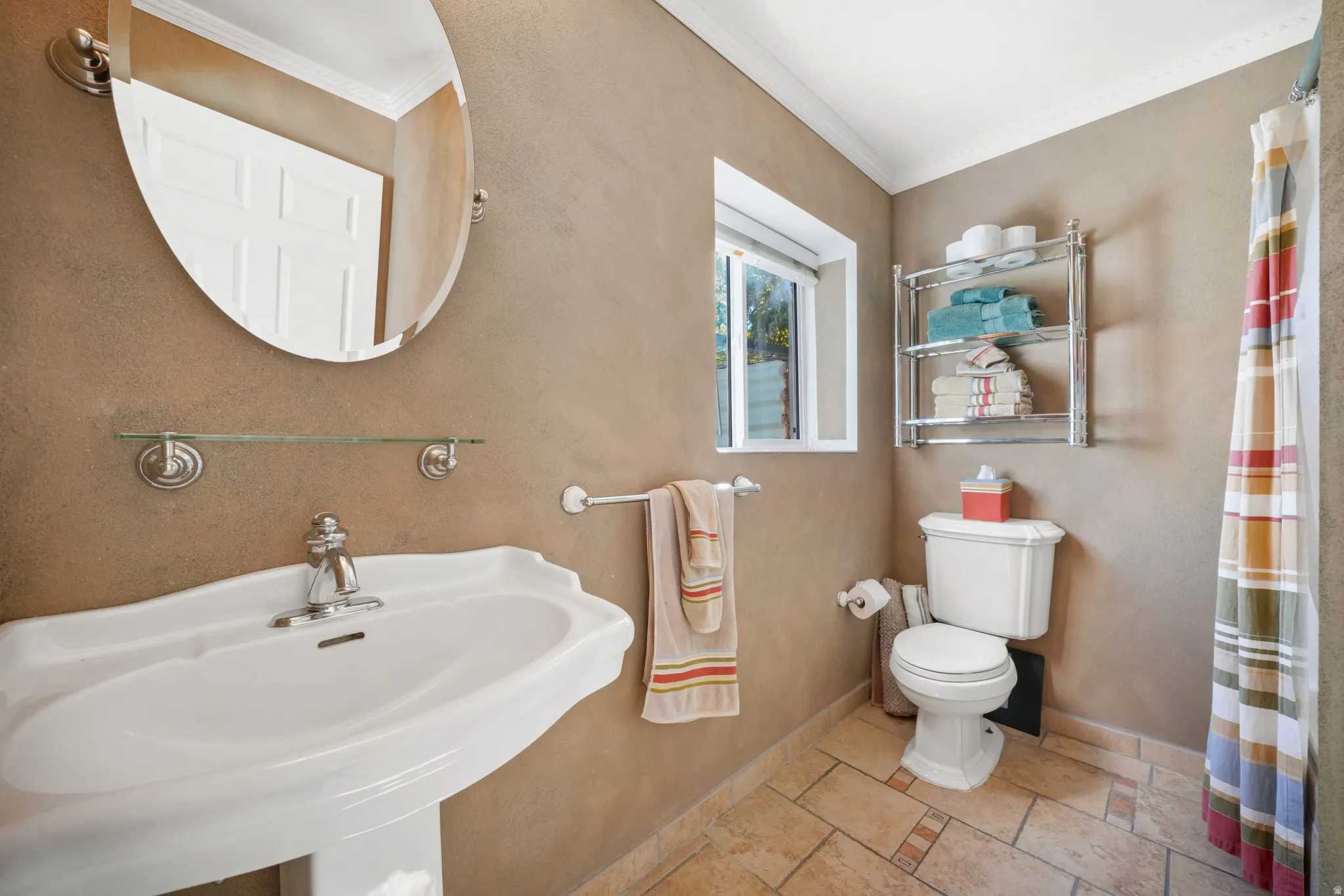 Full bath with a shower with curtain and crown molding