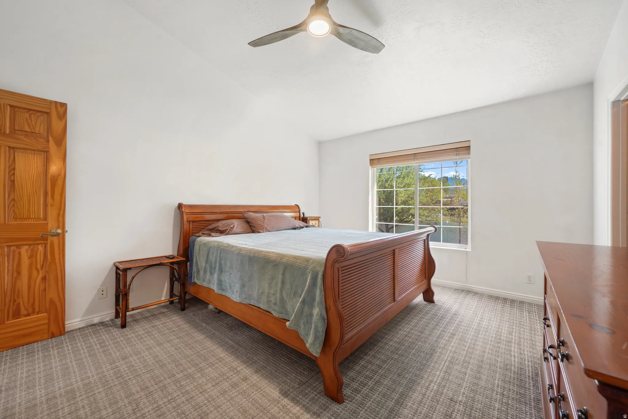 Master Bedroom featuring lofted ceiling, carpet flooring, and ceiling fan