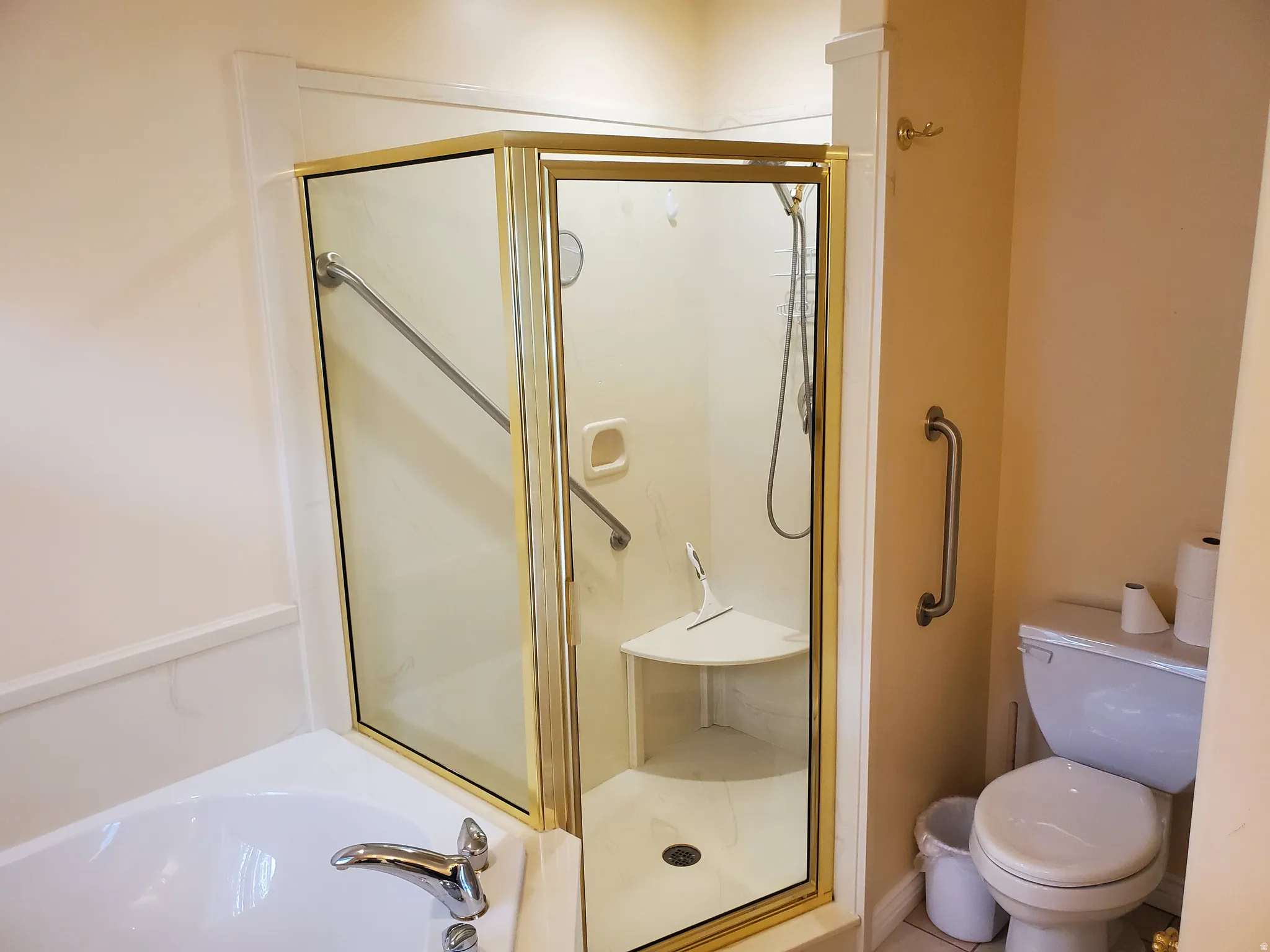 Bathroom with a stall shower and a garden tub