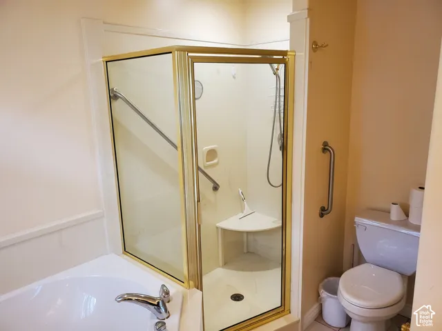 Bathroom with a stall shower and a garden tub