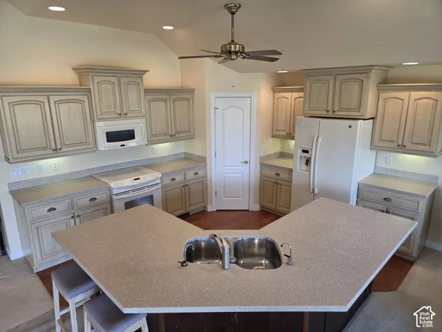 Kitchen featuring a dual-basin sink, light-toned cabinetry, recessed lighting, a ceiling fan, and wood-finish flooring
