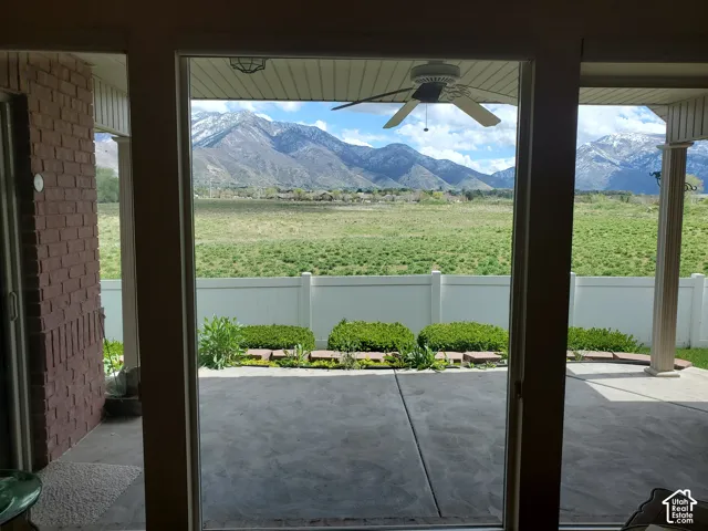 Doorway to outside featuring a mountain view and ceiling fan