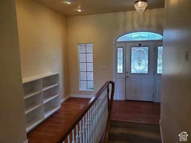 Entryway featuring a chandelier and dark wood-style floors