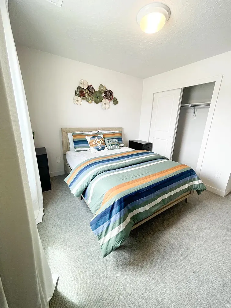 Bedroom with carpet, a closet, and a textured ceiling