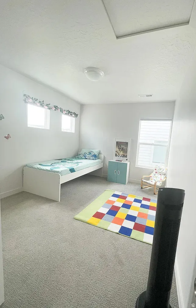 Carpeted bedroom with a textured ceiling