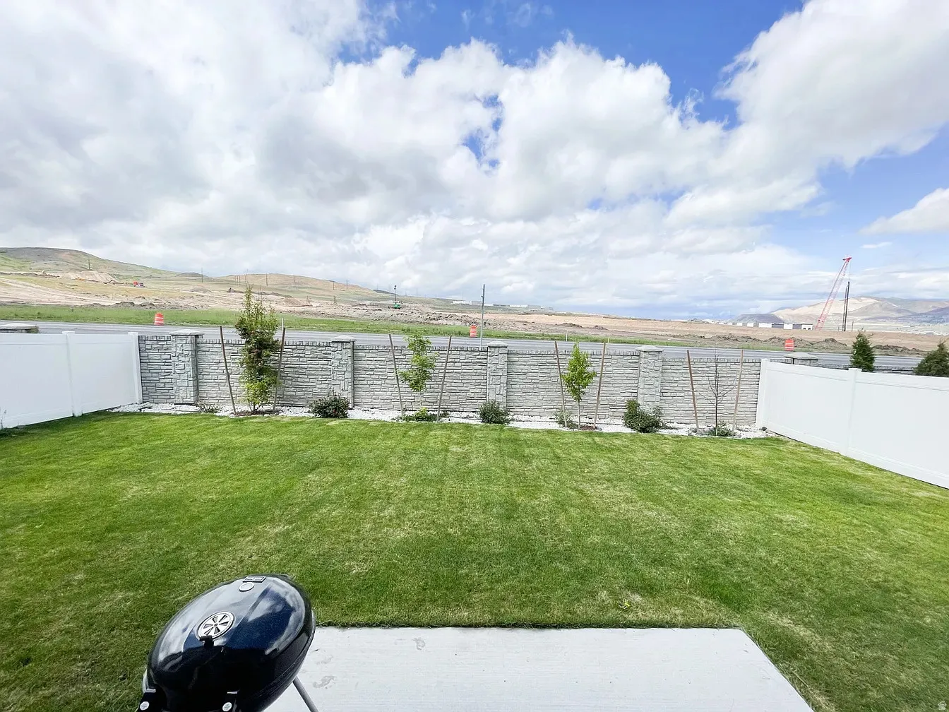 Fenced backyard with a mountain view