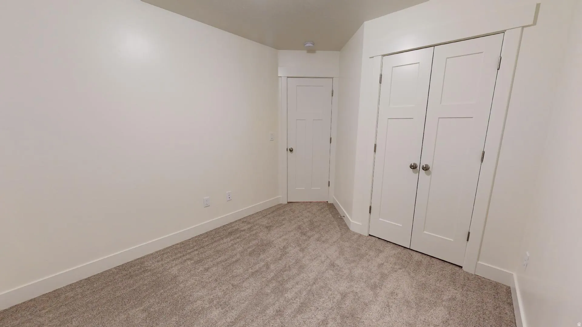 Unfurnished bedroom with a closet and light carpet