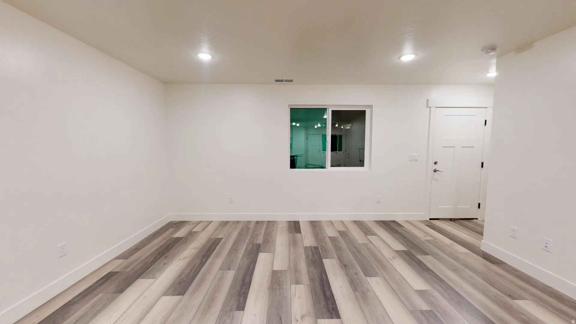Unfurnished room featuring light wood-type flooring and recessed lighting