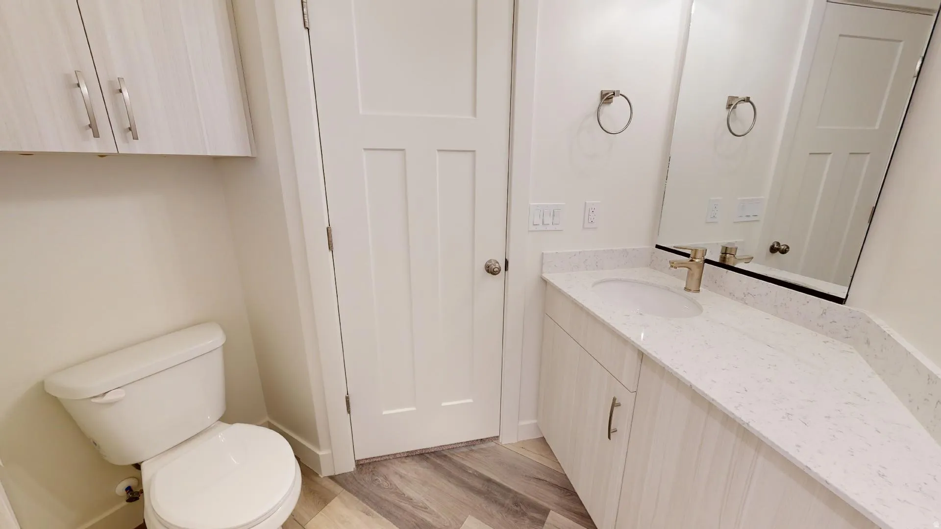 Half bath featuring vanity and light wood-style floors