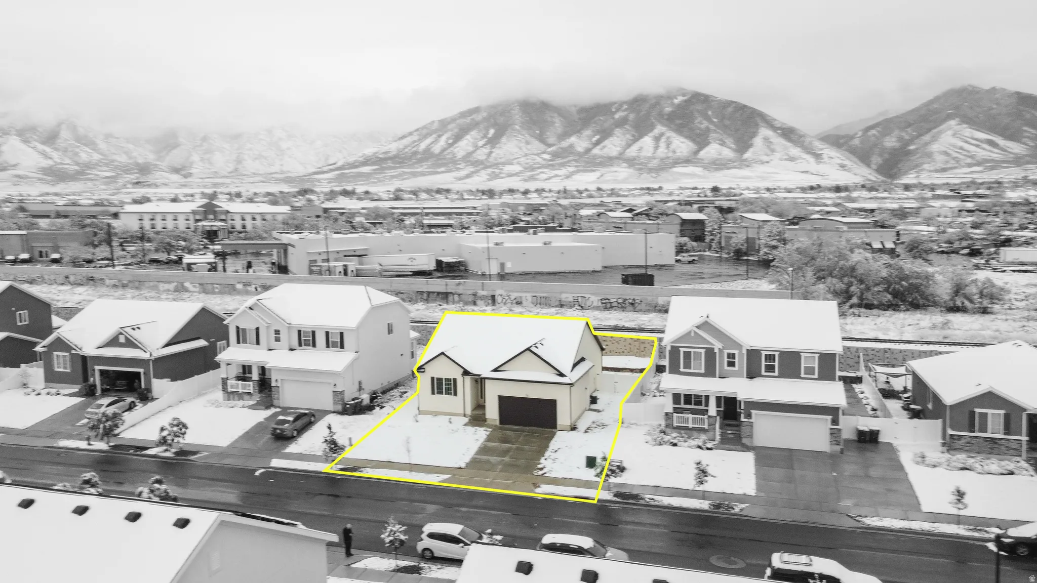 Aerial view of residential area featuring property parcel outlined and mountains