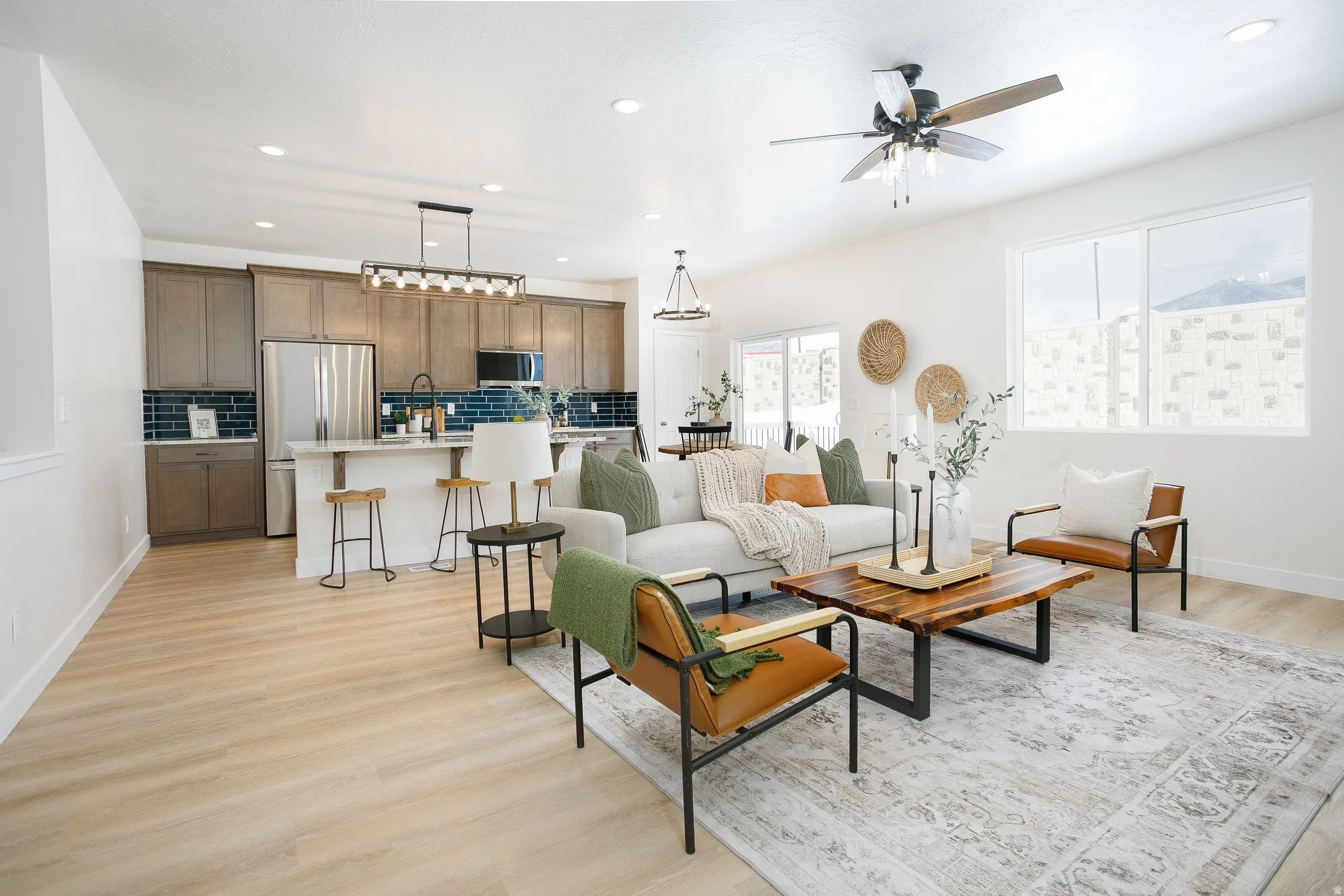 Living room featuring light wood-type flooring, recessed lighting, and ceiling fan