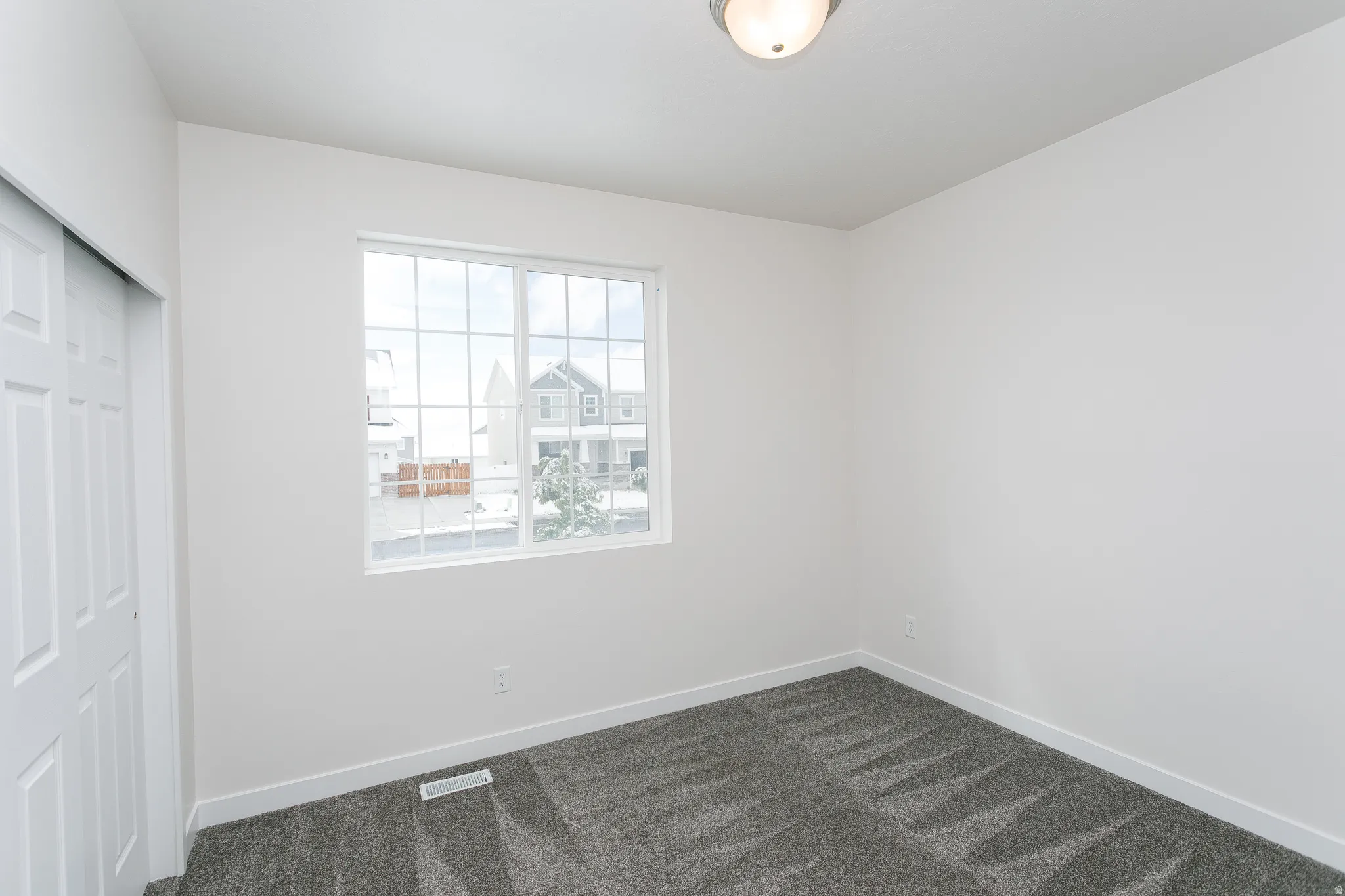 Unfurnished bedroom with a closet and dark colored carpet