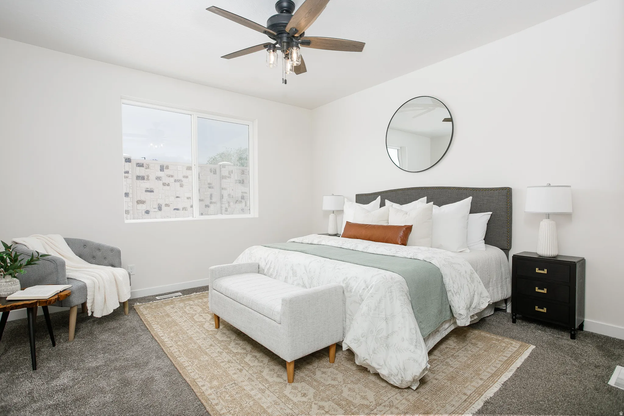 Bedroom with dark colored carpet and a ceiling fan