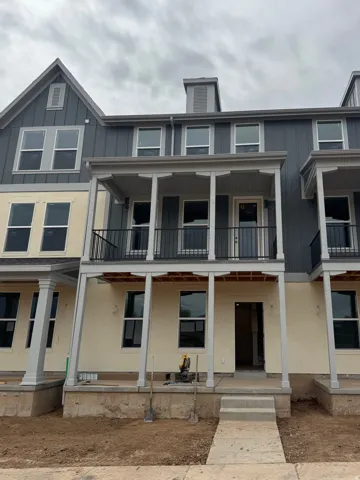 View of front of home with board and batten siding and a porch