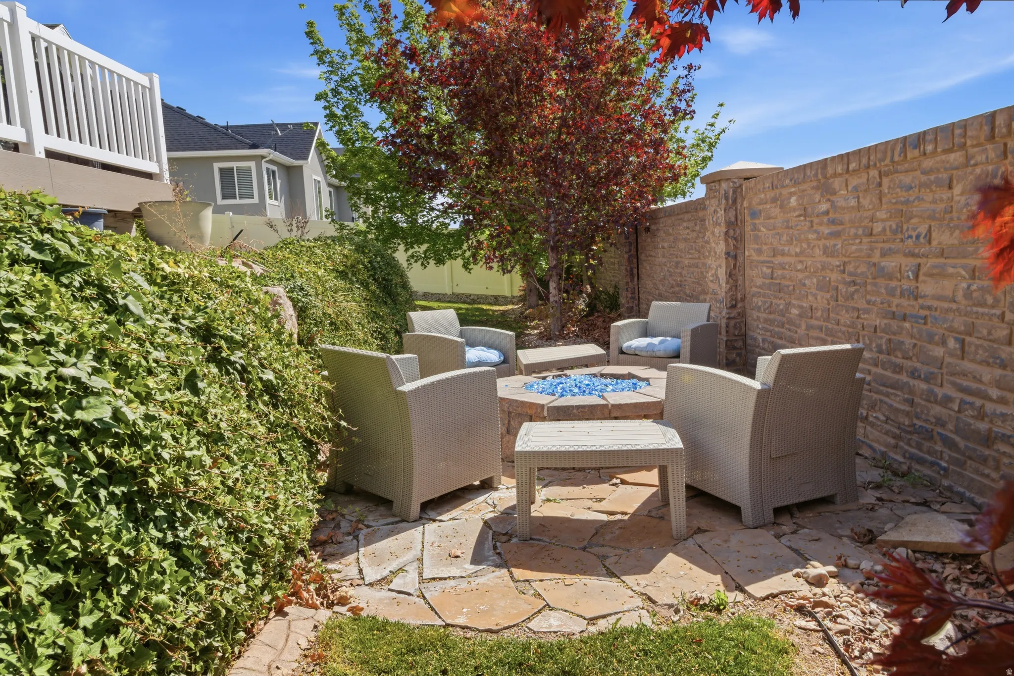 Fenced backyard with a patio and an outdoor fire pit