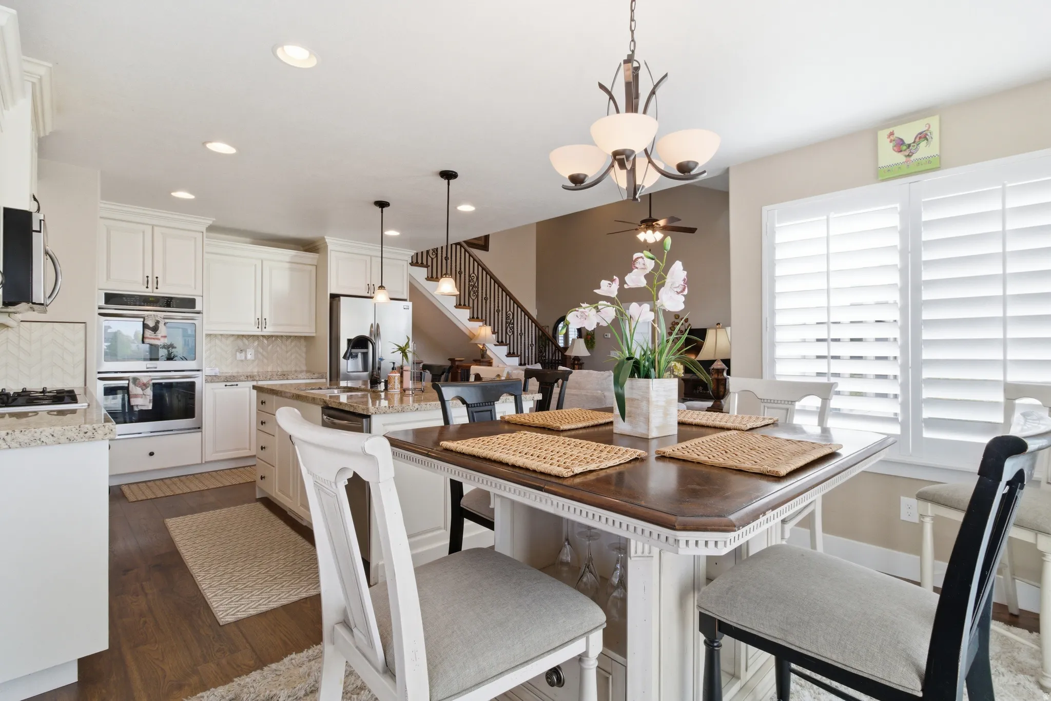 Dining room with dark wood-type flooring and recessed lighting