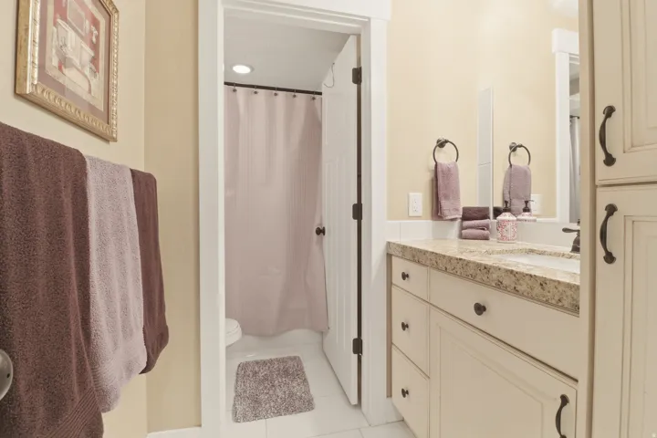 Full bath featuring vanity, curtained shower, and tile flooring