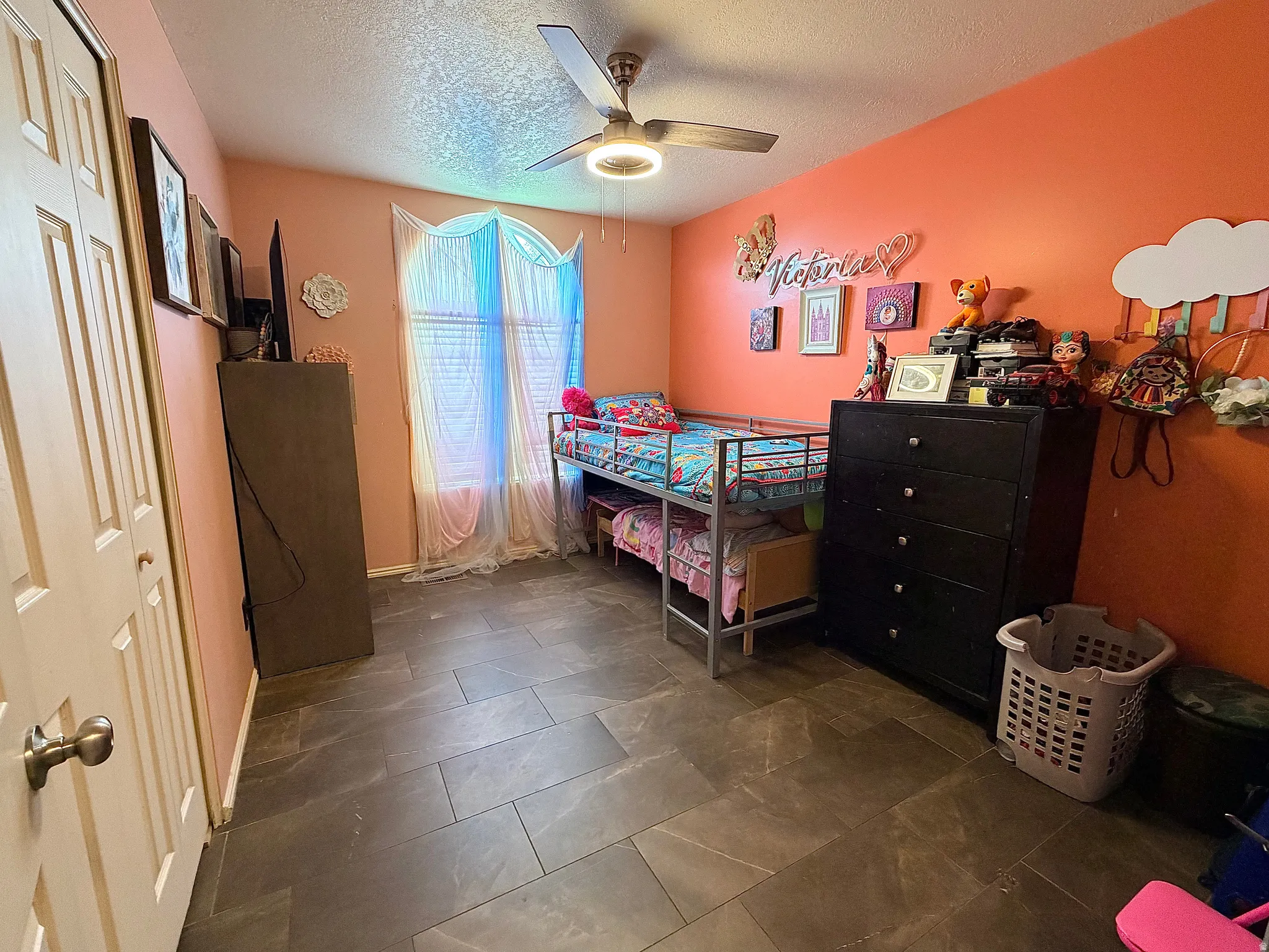 Bedroom featuring a closet, a textured ceiling, and a ceiling fan