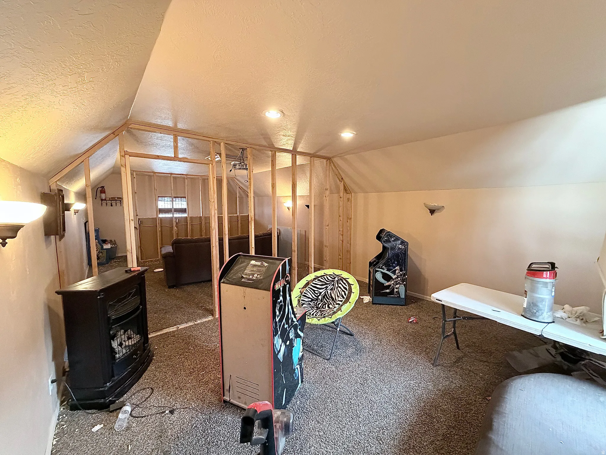 Bonus room featuring a textured ceiling and carpet