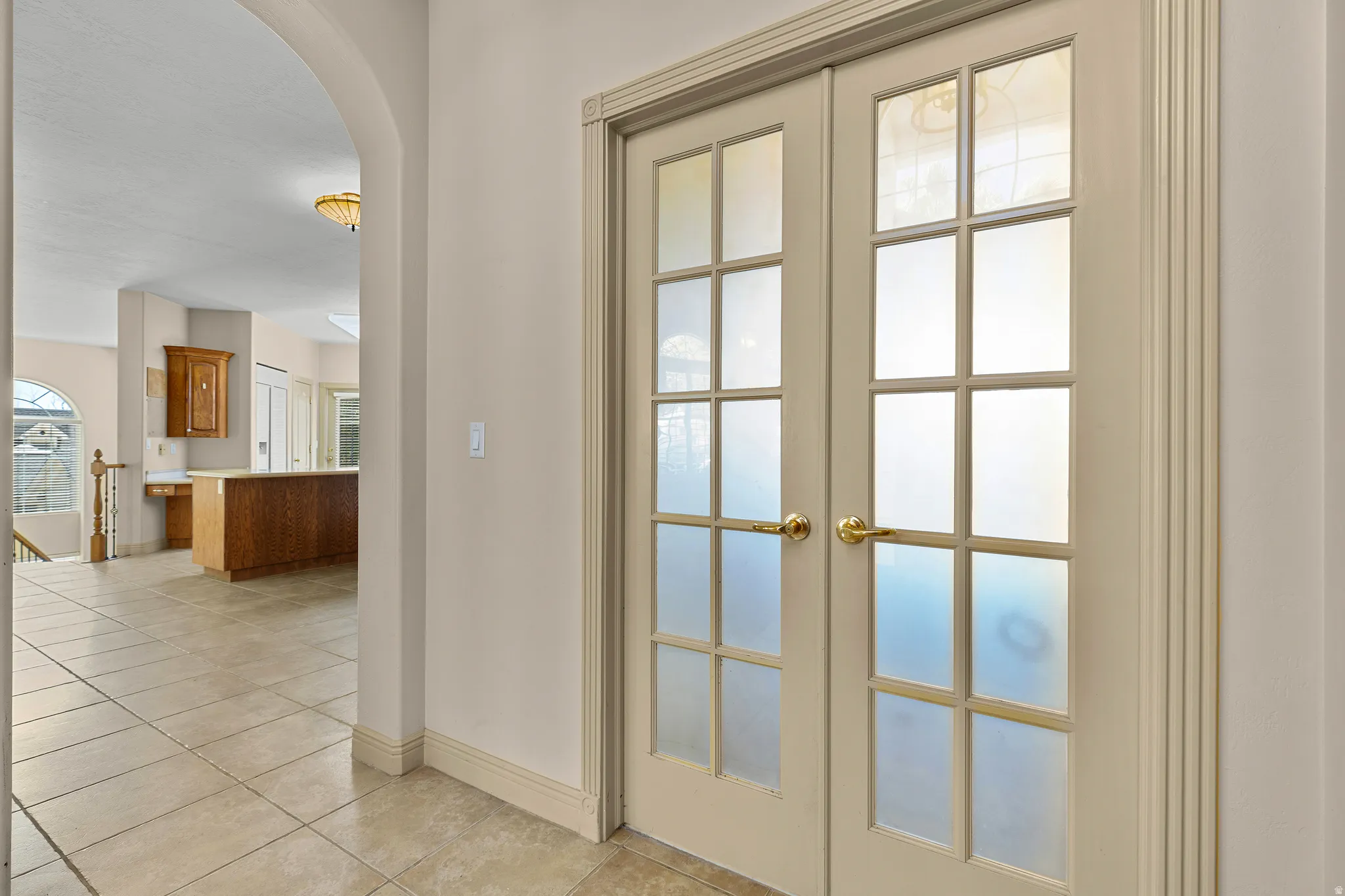 Detailed view of french doors and arched walkways