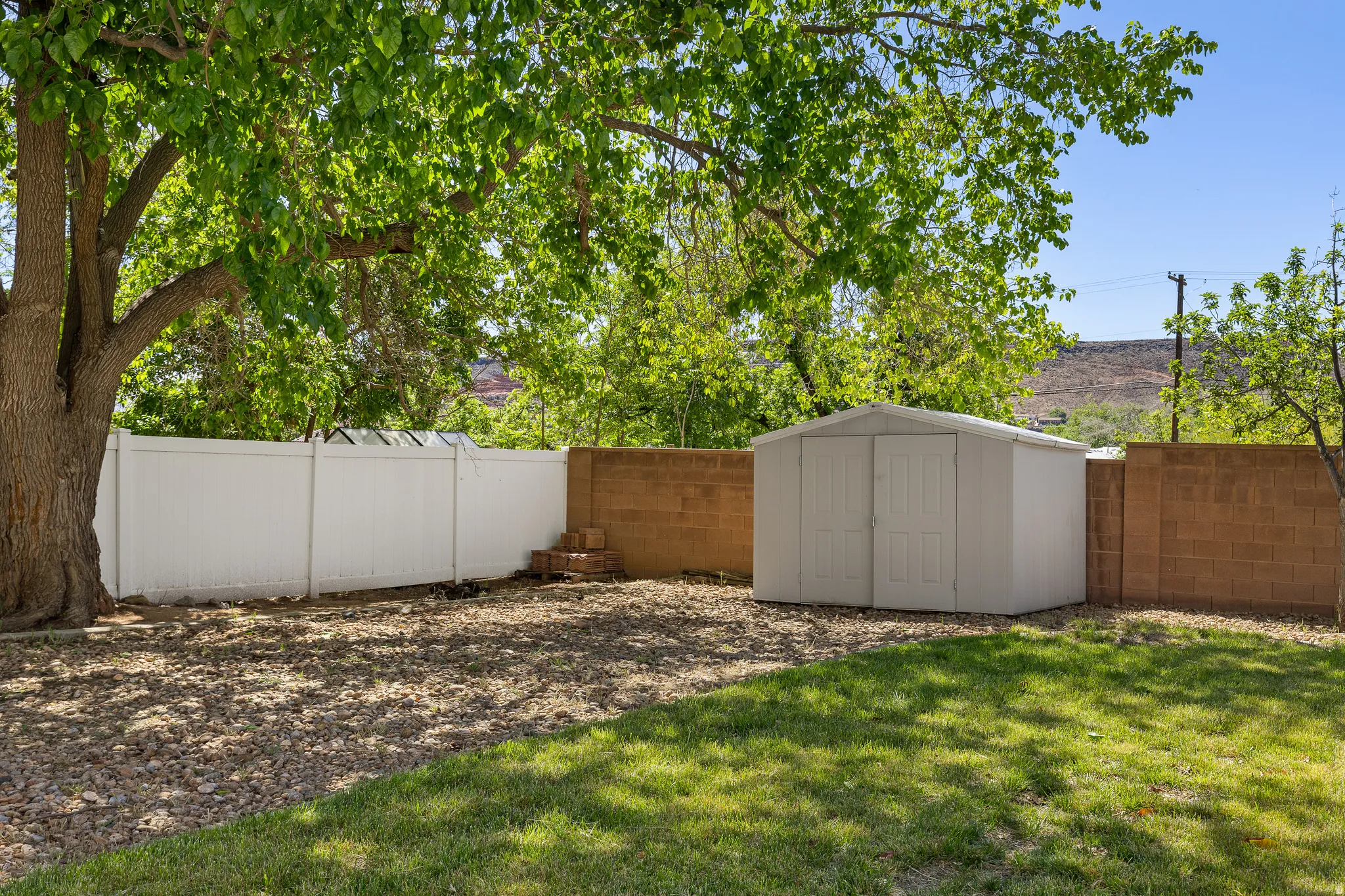Fenced backyard with a shed