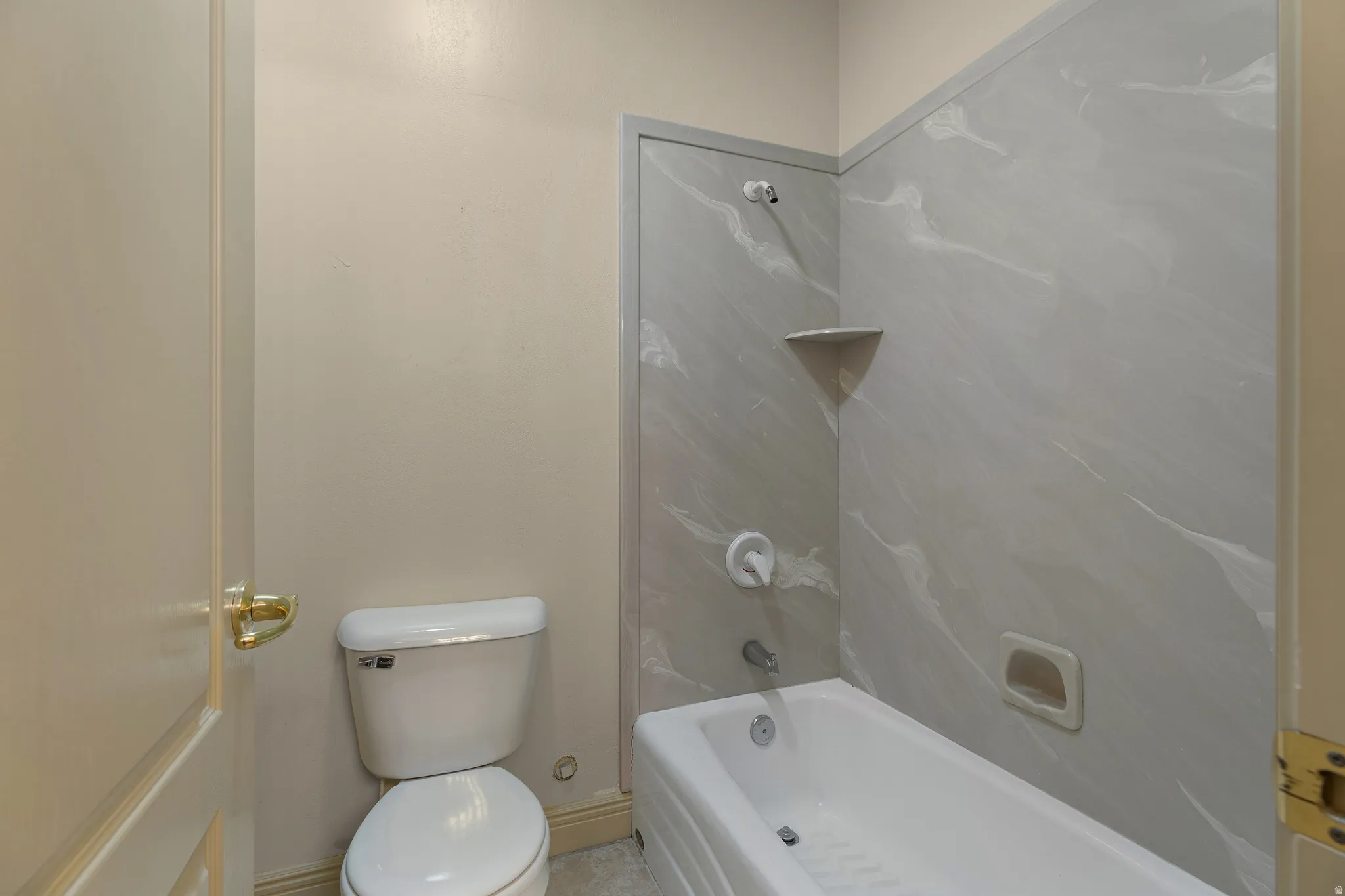 Bathroom with toilet and shower / bathtub combination