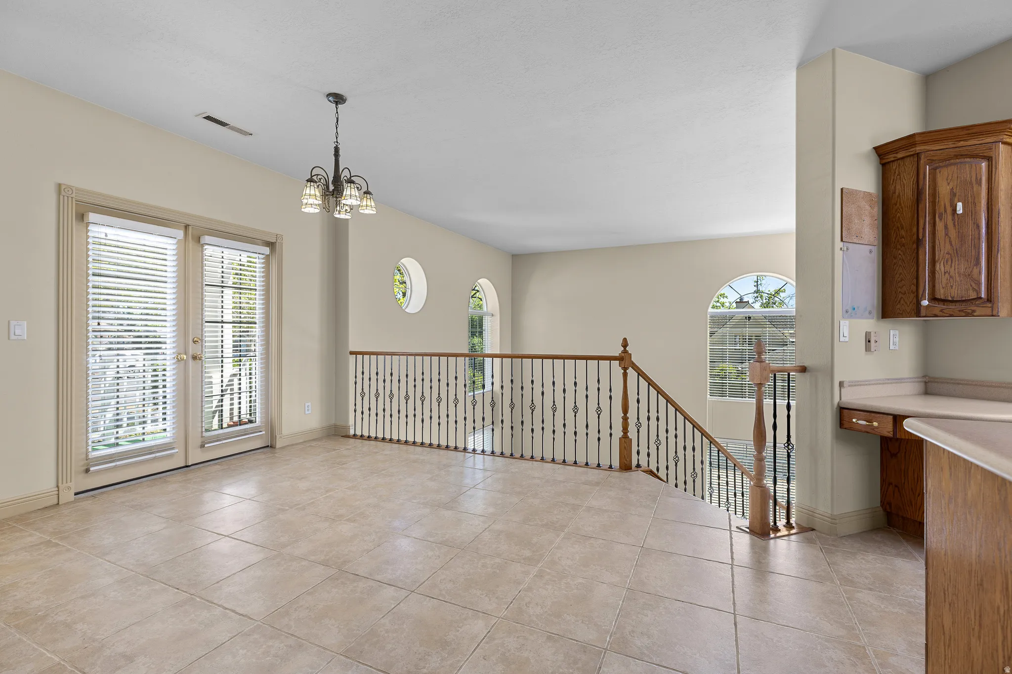 Unfurnished dining area featuring light tile patterned flooring and hanging lights