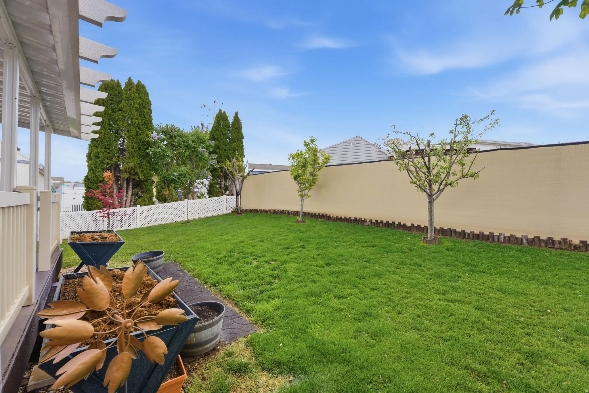 Fenced backyard with a patio area
