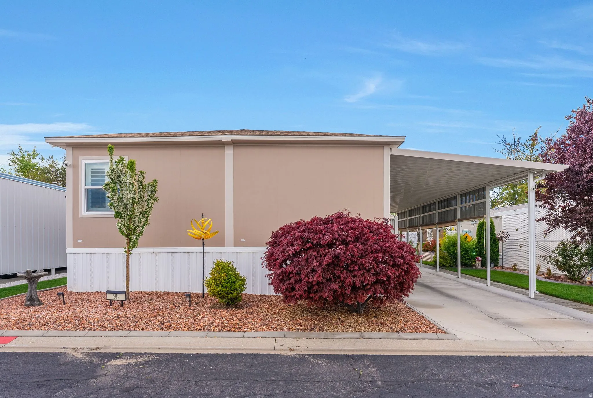 View of side of property with an attached carport and concrete driveway