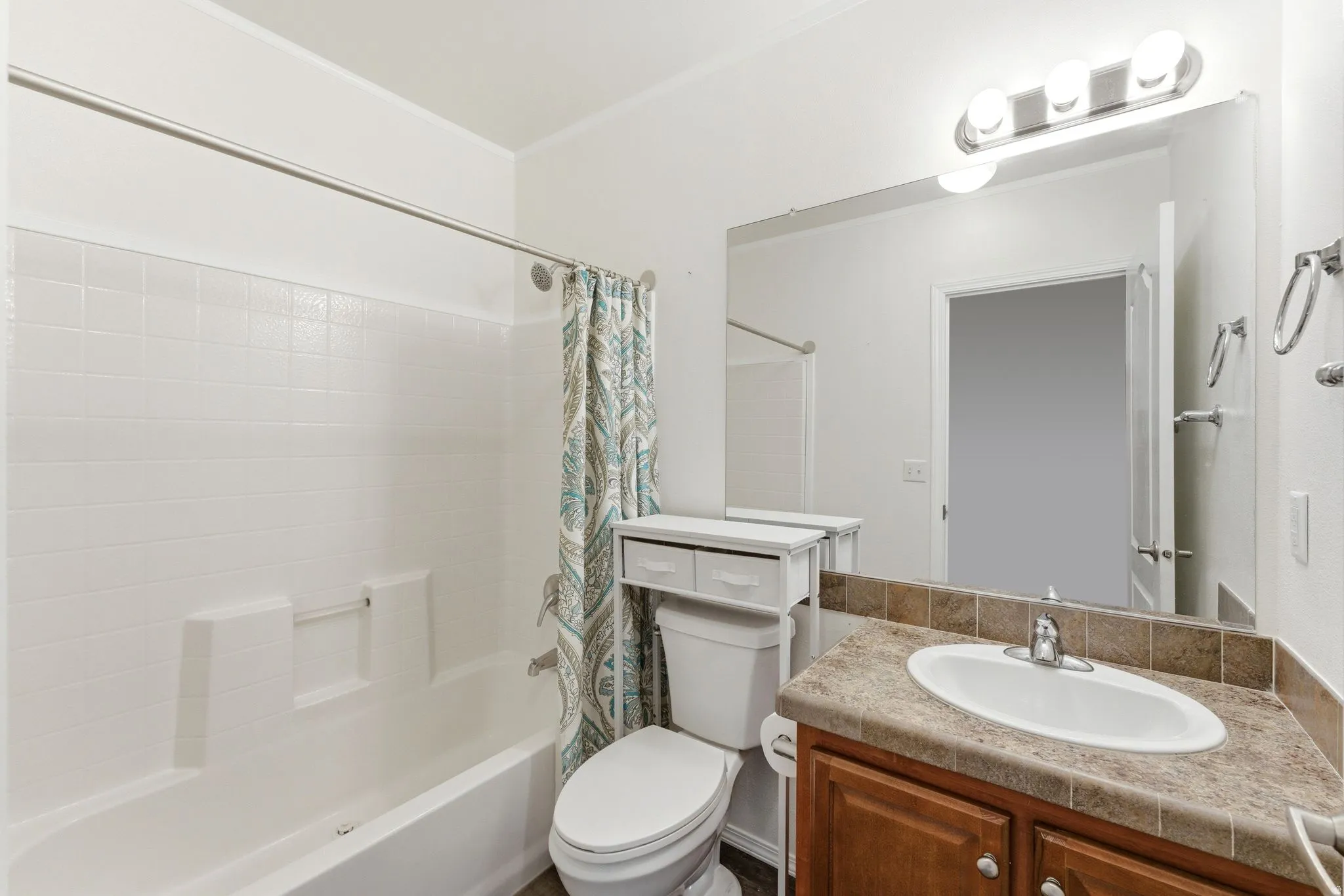Full bathroom with vanity and shower / bath combination with curtain
