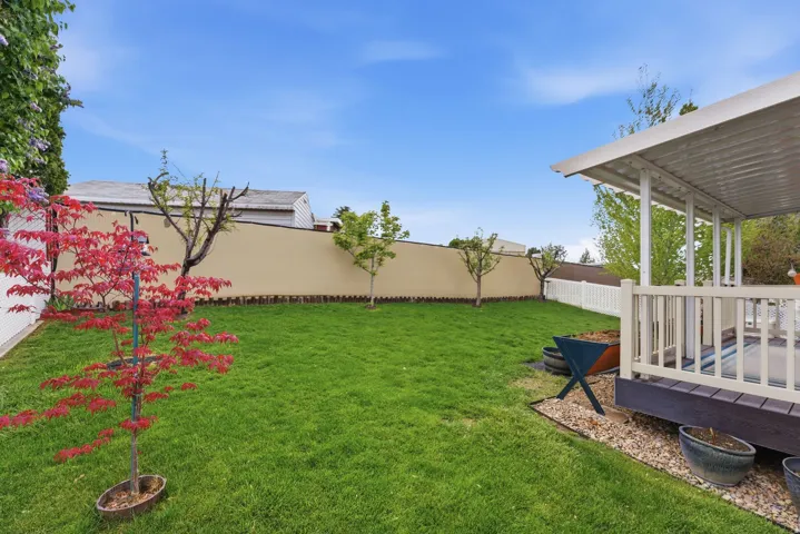 Fenced backyard with a wooden deck
