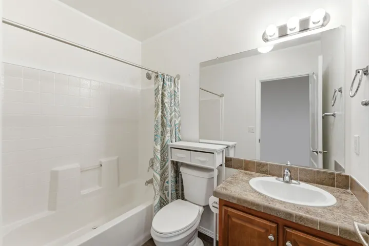 Full bathroom with vanity and shower / bath combination with curtain