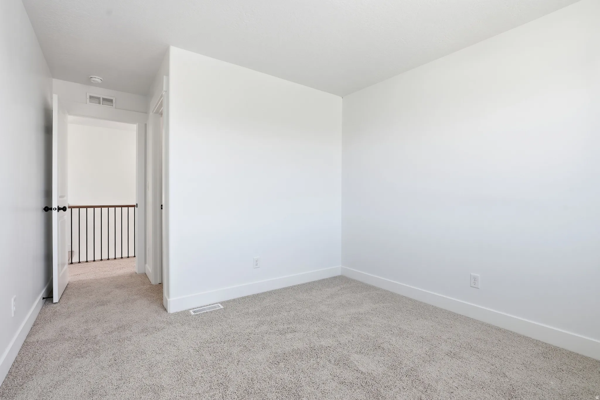 Unfurnished room with light carpet and baseboards