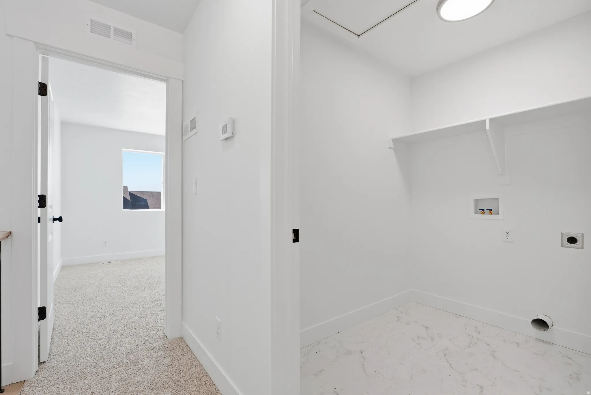 Laundry area featuring washer hookup, hookup for an electric dryer, and light colored carpet