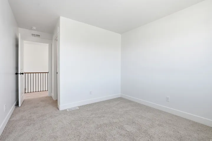 Unfurnished room with light carpet and baseboards