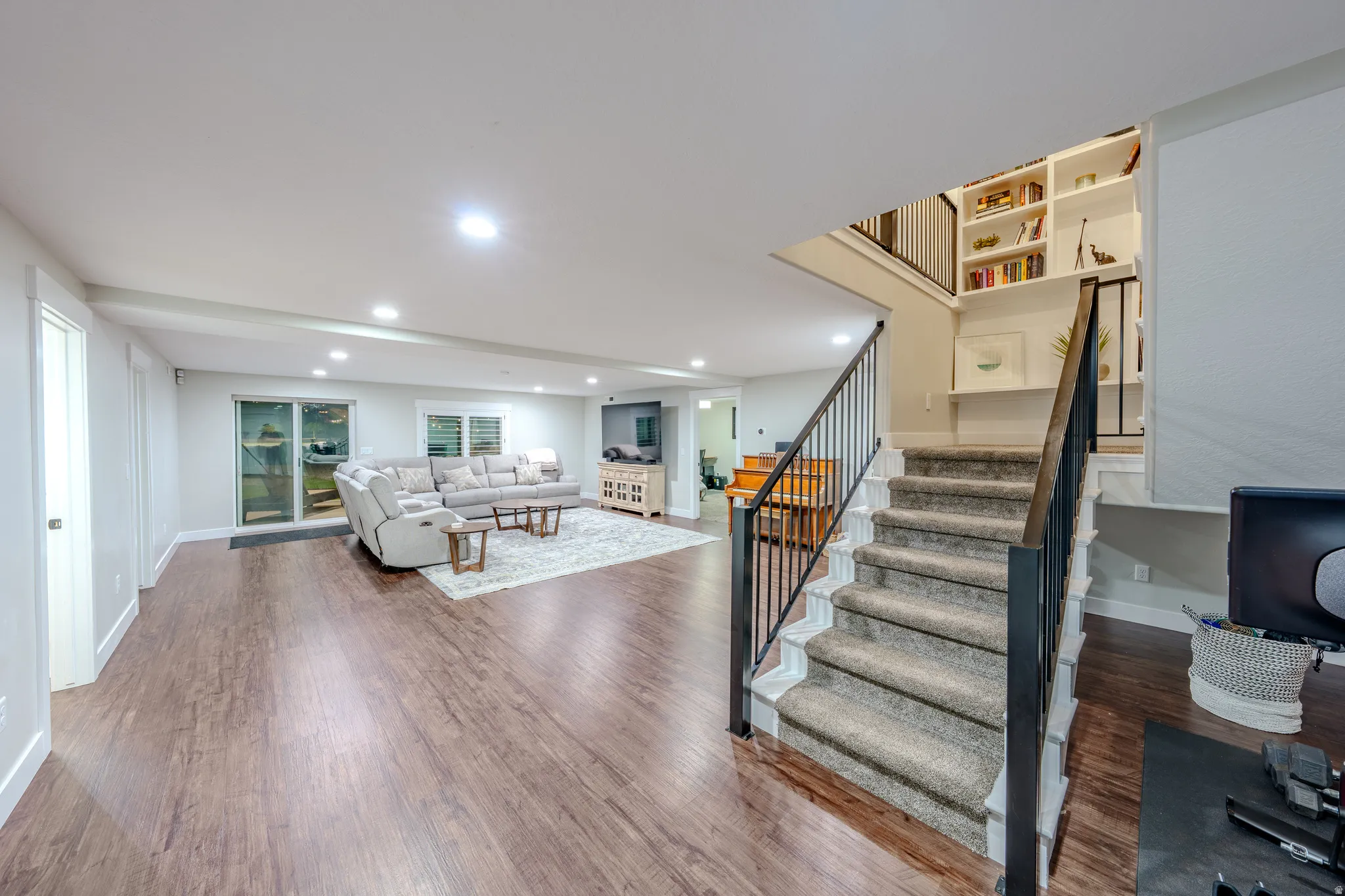 Living room with dark wood-type flooring and recessed lighting