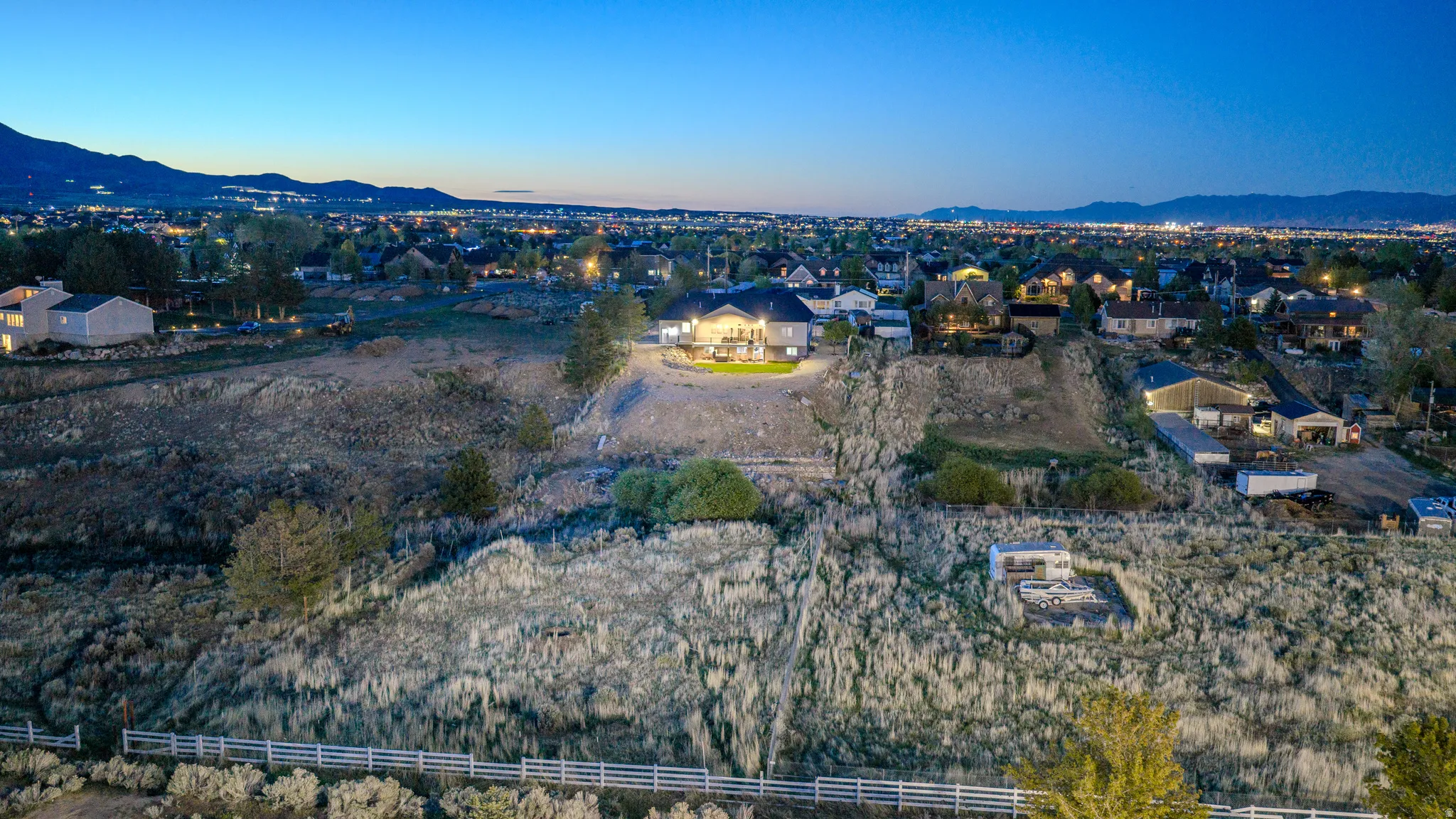Aerial view of property's location featuring a mountainous background and nearby suburban area