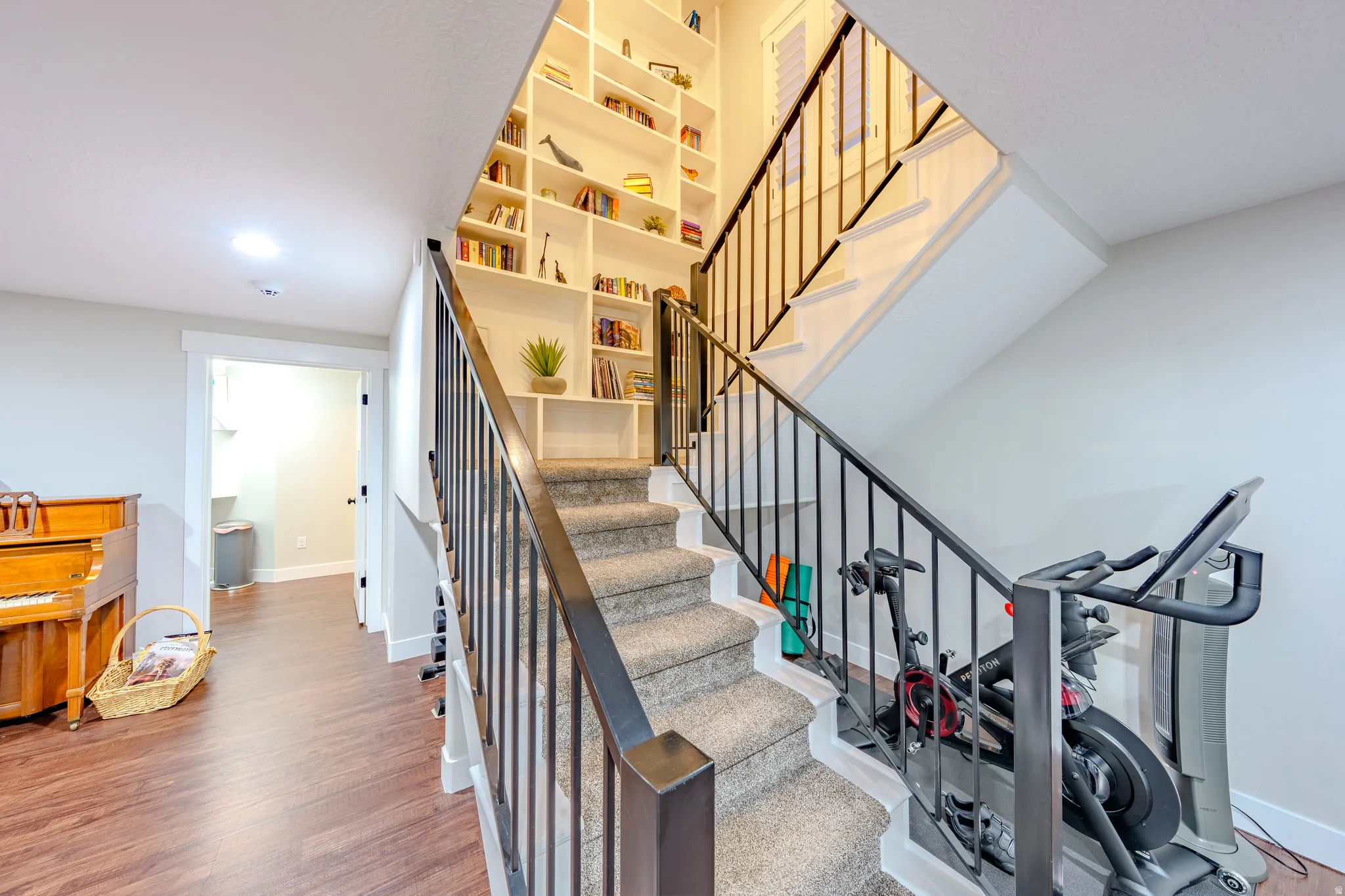 Stairway with baseboards and wood finished floors