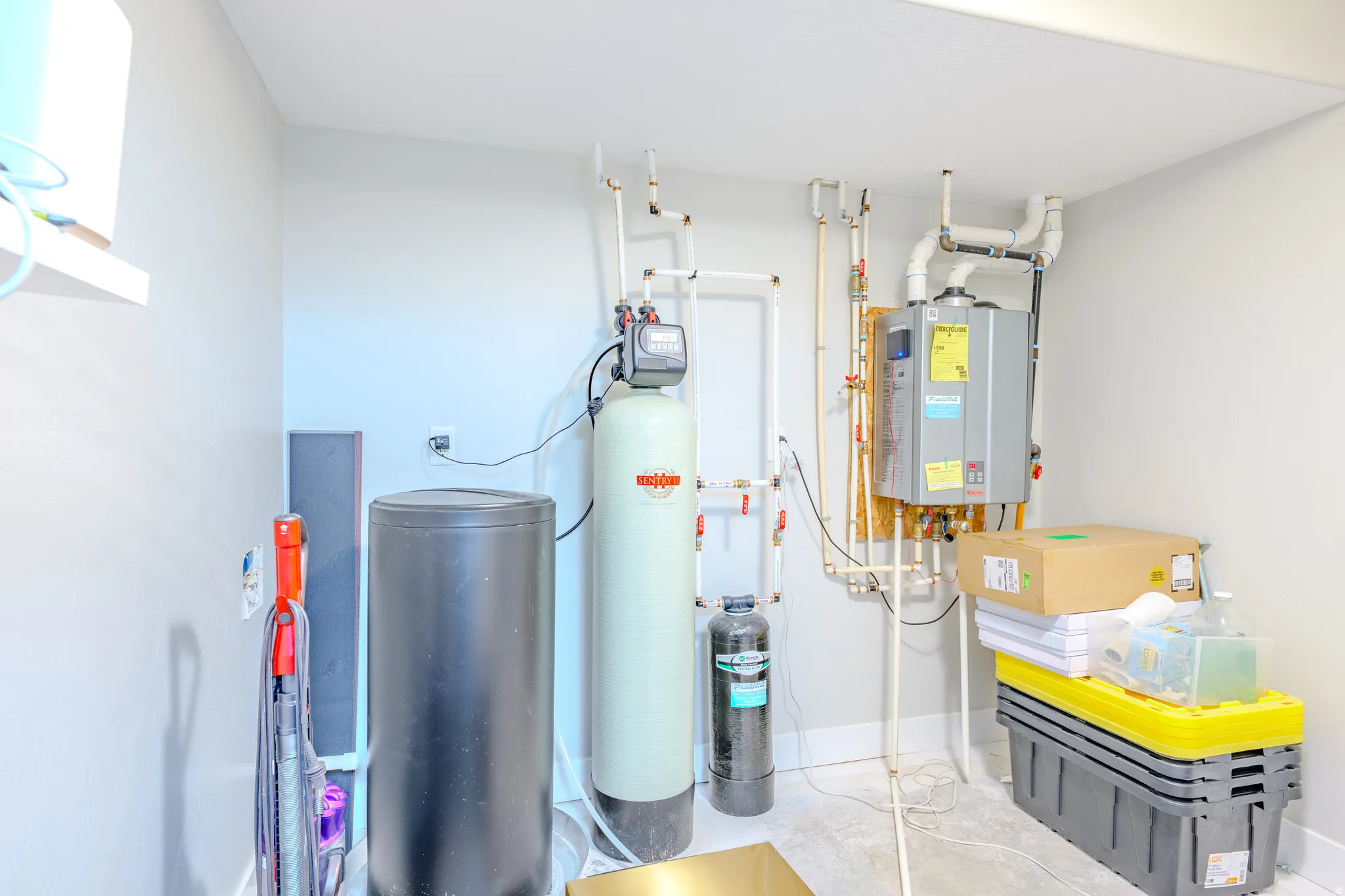 Utility room featuring tankless water heater