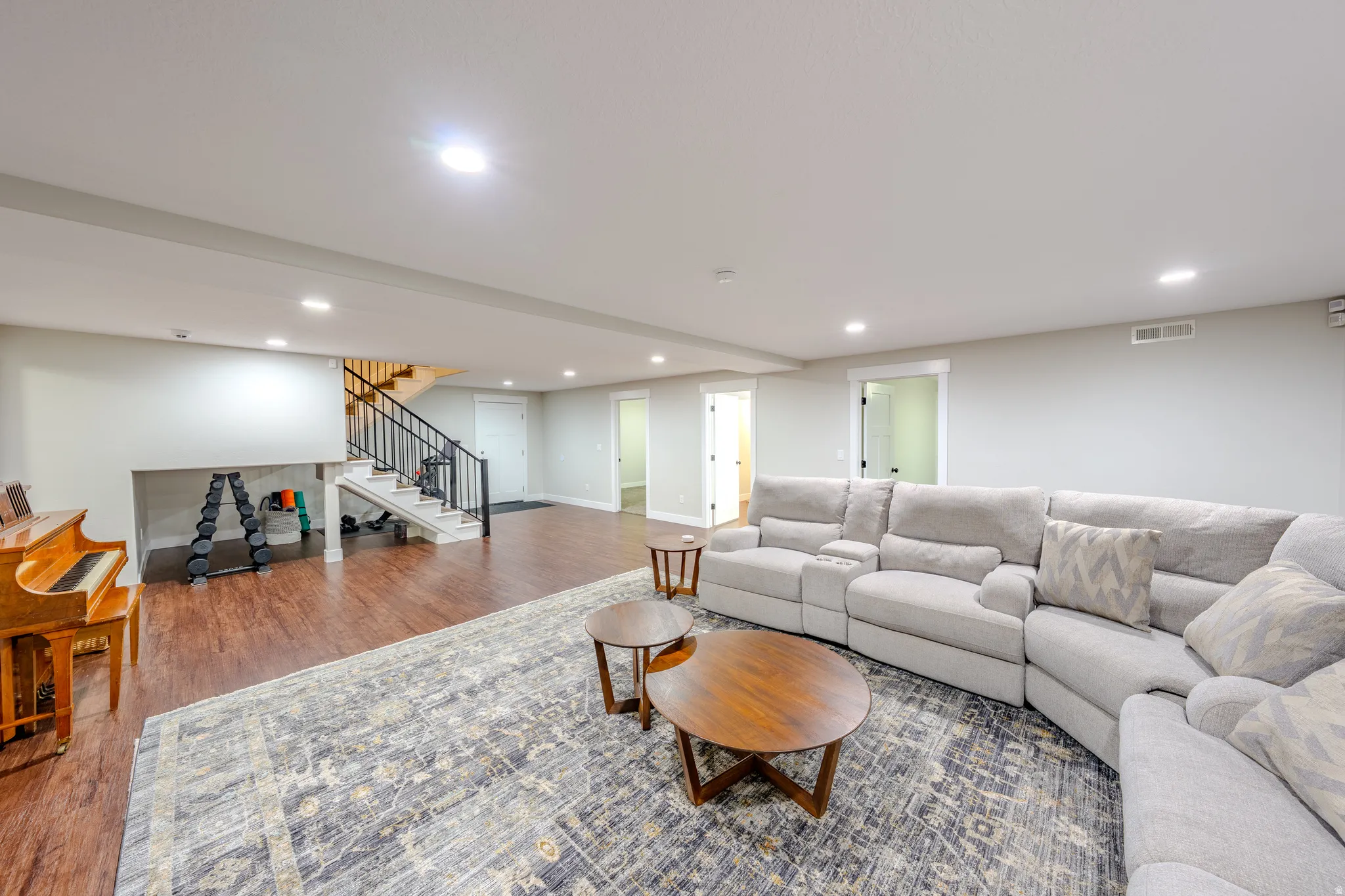 Living area with wood finished floors and recessed lighting