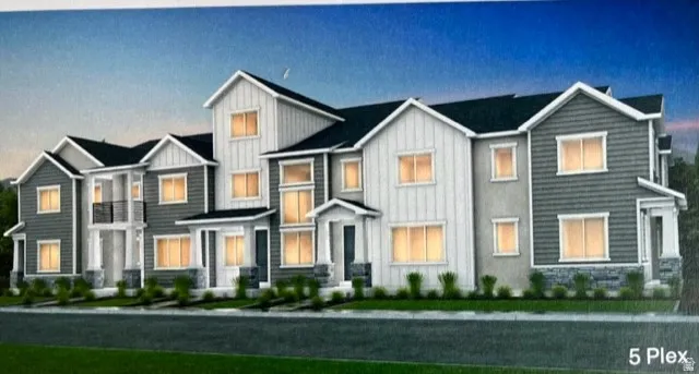 View of front of home featuring board and batten siding and stone siding