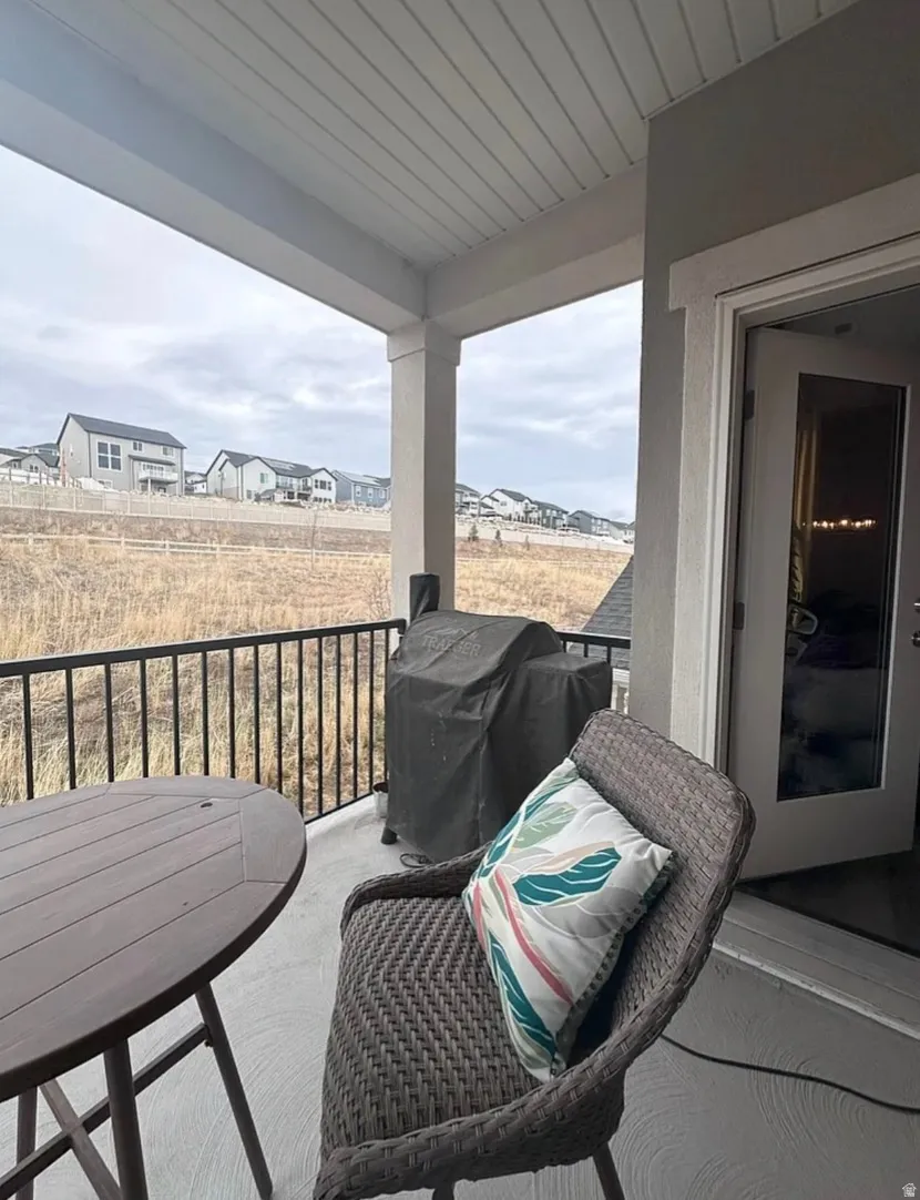 Balcony featuring area for grilling and a residential view