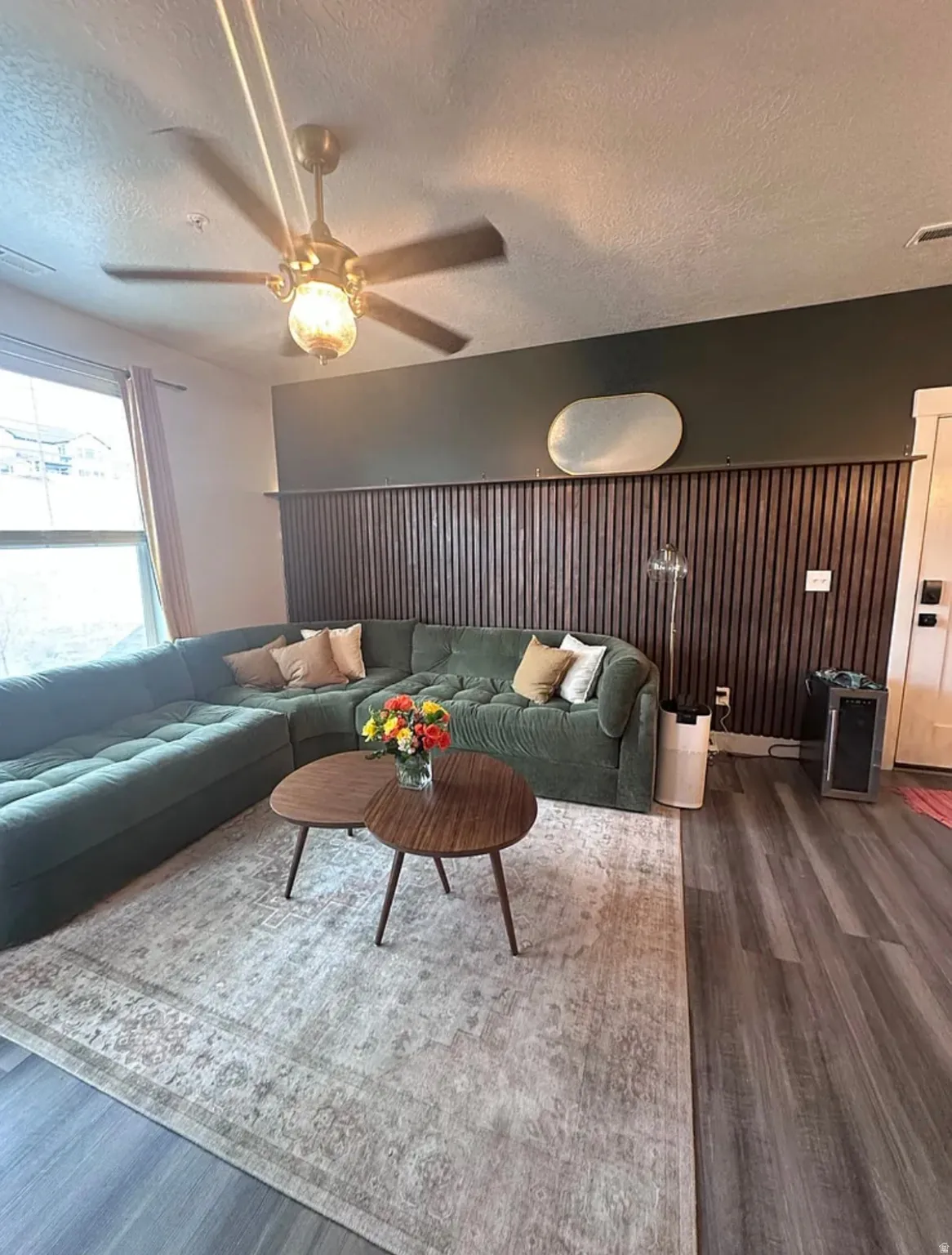 Living area with dark wood finished floors and a textured ceiling