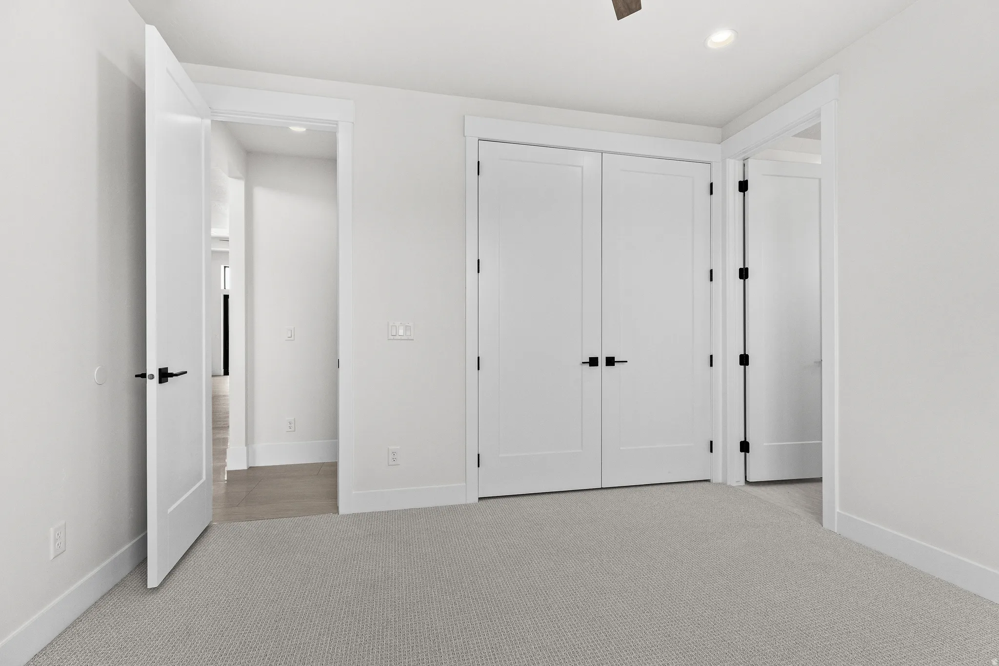 Unfurnished bedroom with light colored carpet, recessed lighting, ceiling fan, and a closet