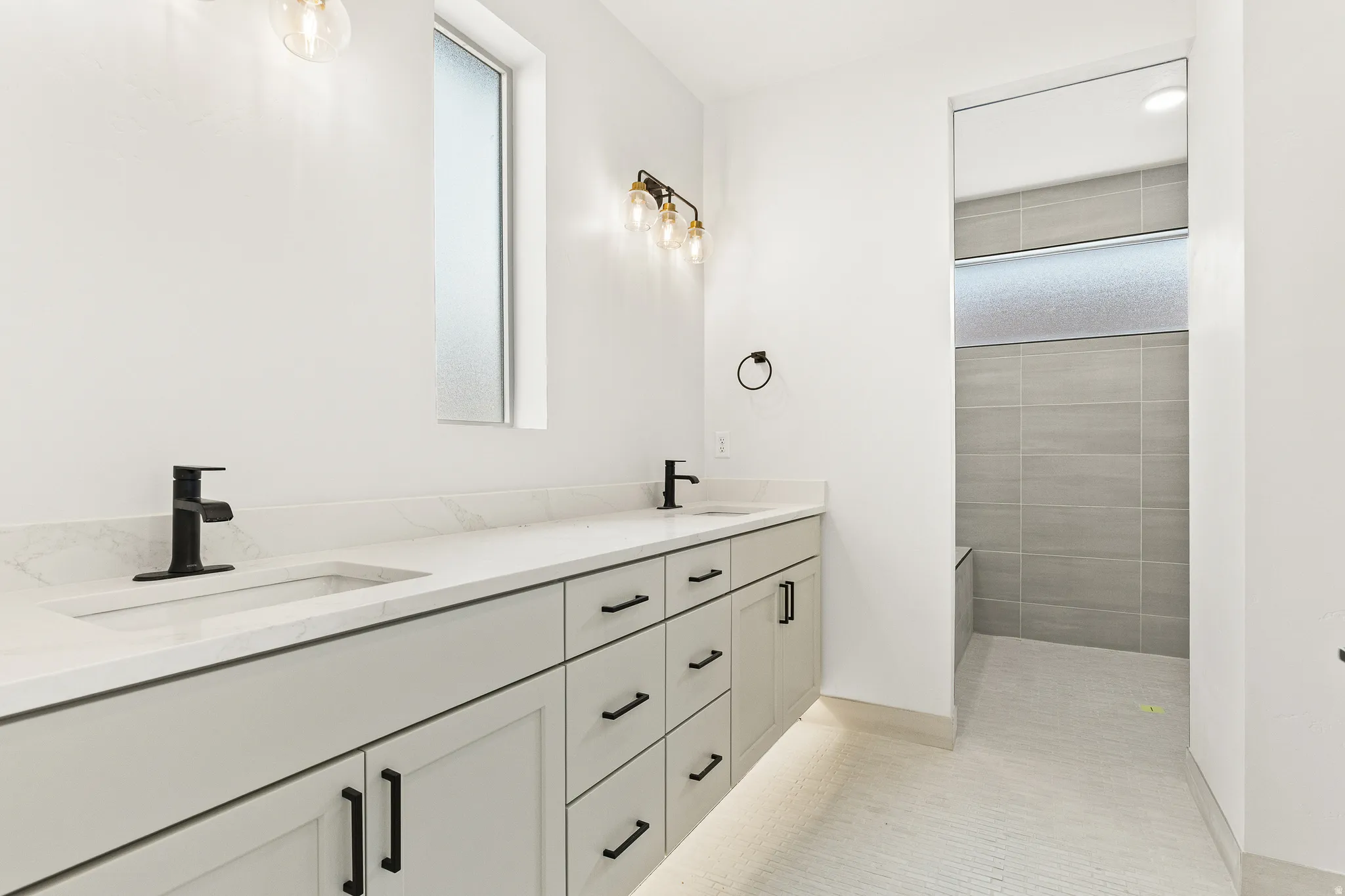 Full bathroom featuring double vanity and a walk in shower
