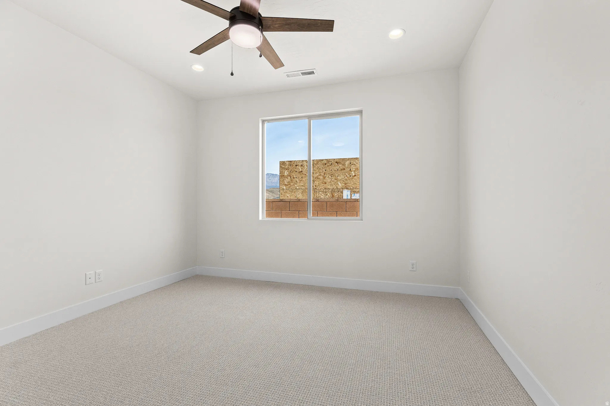 Spare room with light carpet, ceiling fan, and recessed lighting