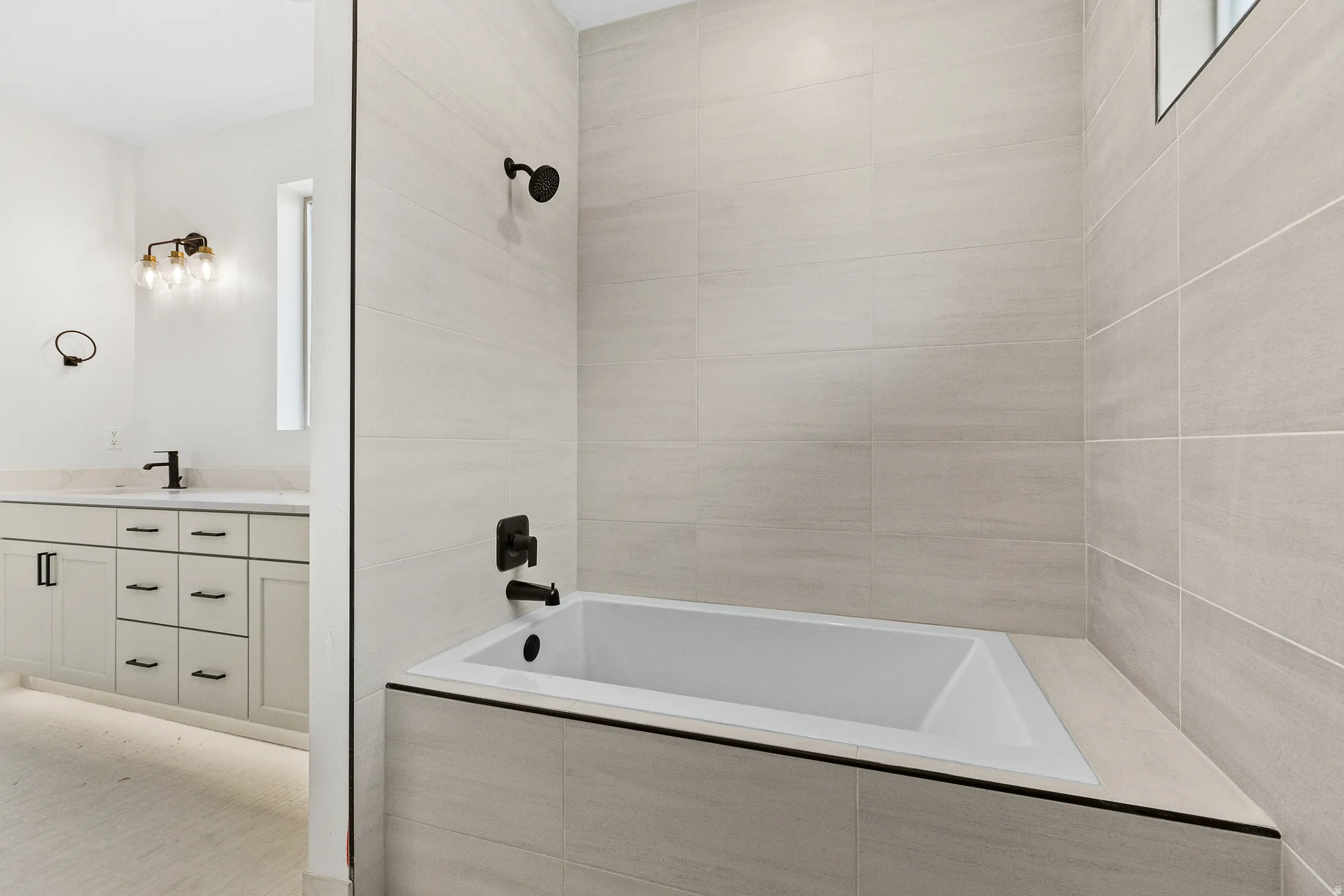 Bathroom featuring tiled shower / bath and vanity