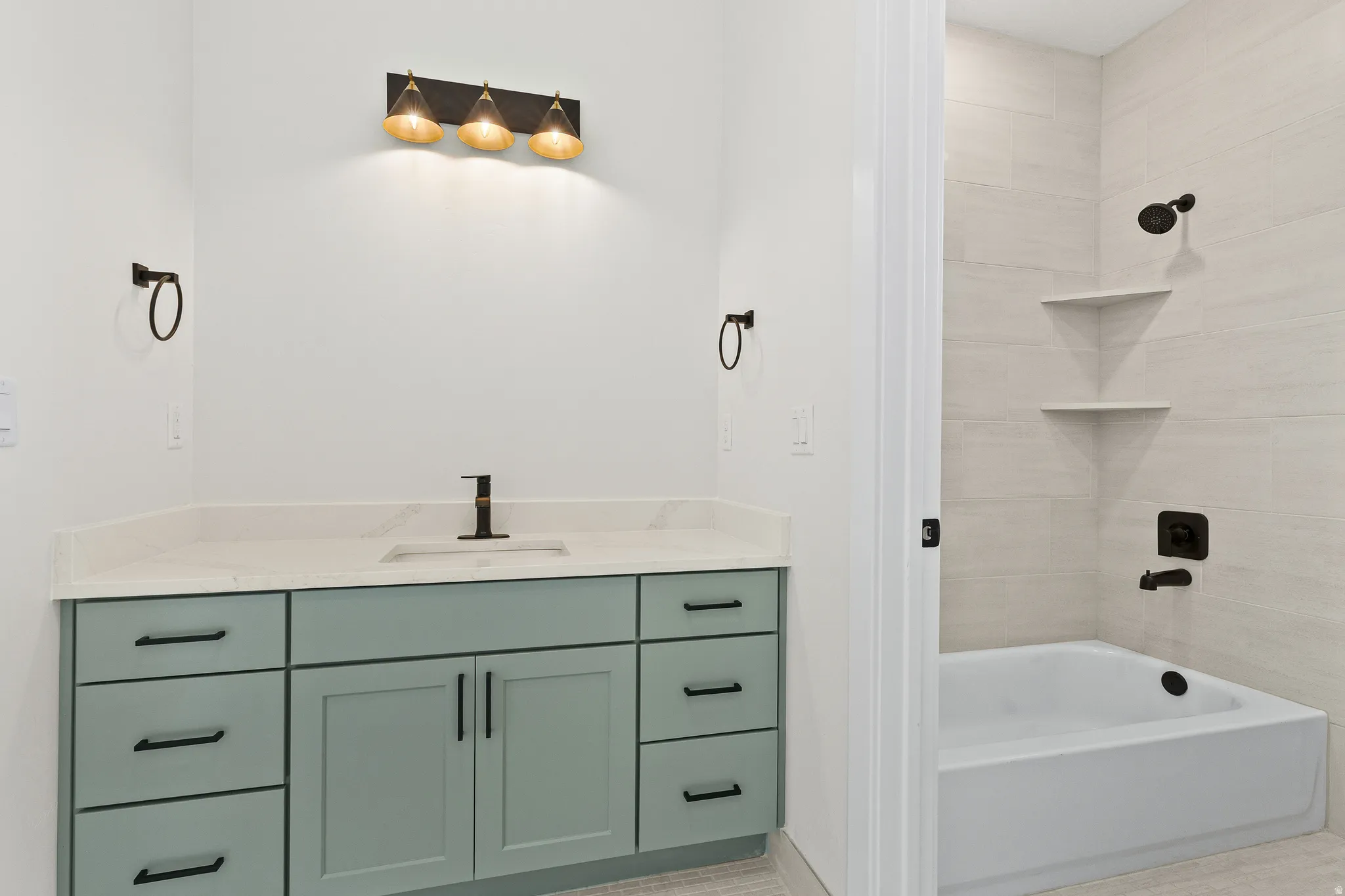 Bathroom with vanity and bathing tub / shower combination